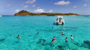 Private BVI power boat tour from Tortola to a white sand beach with turquoise water and scenic island views