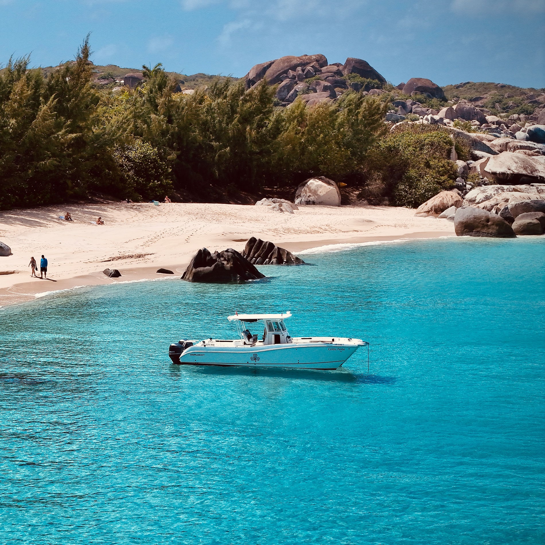 Celtic Wisdom powerboat anchored at Spring Bay Virgin Gorda, while guest take a walk on the beach.