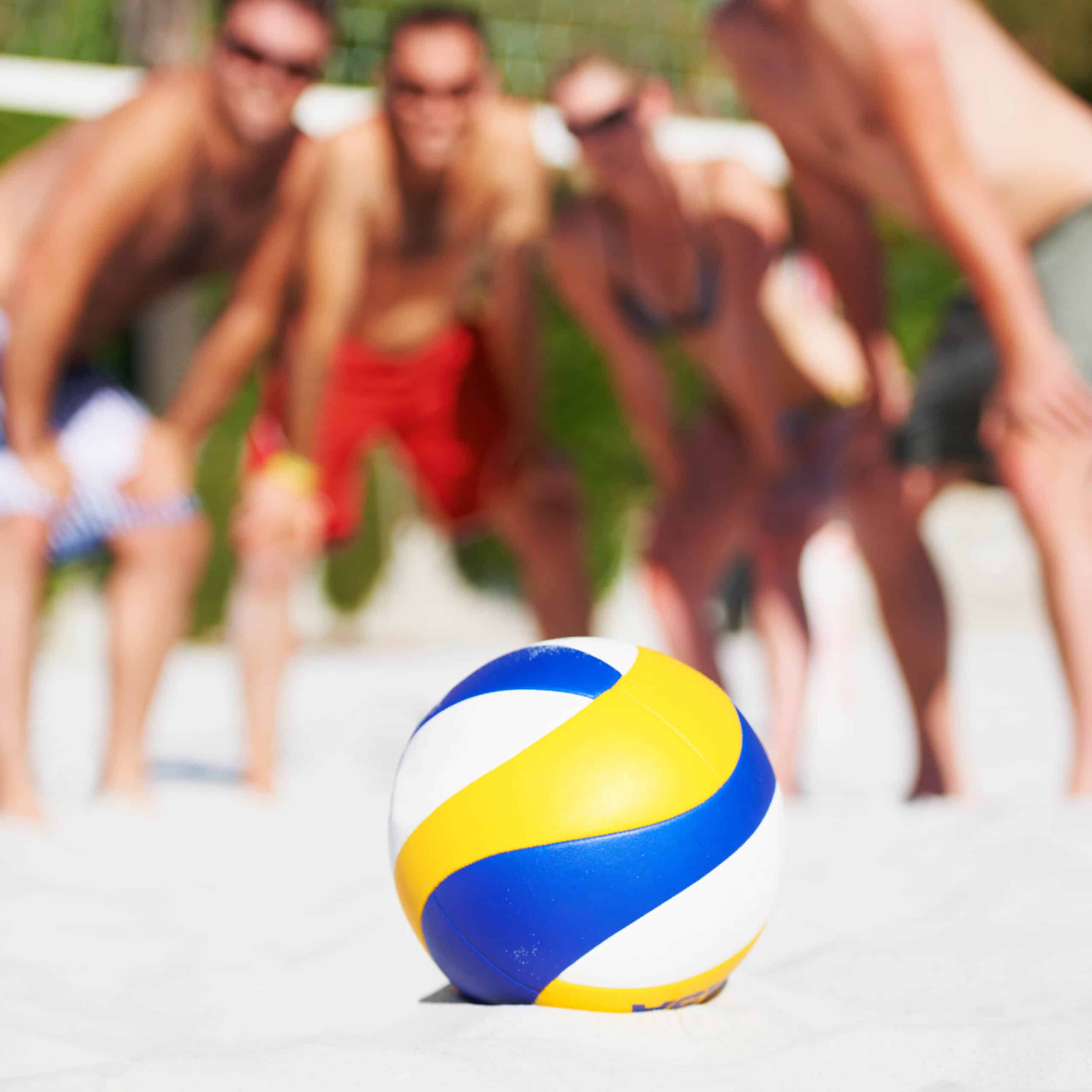 Group of friends pose between matches in the beach volleyball game in the BVI.