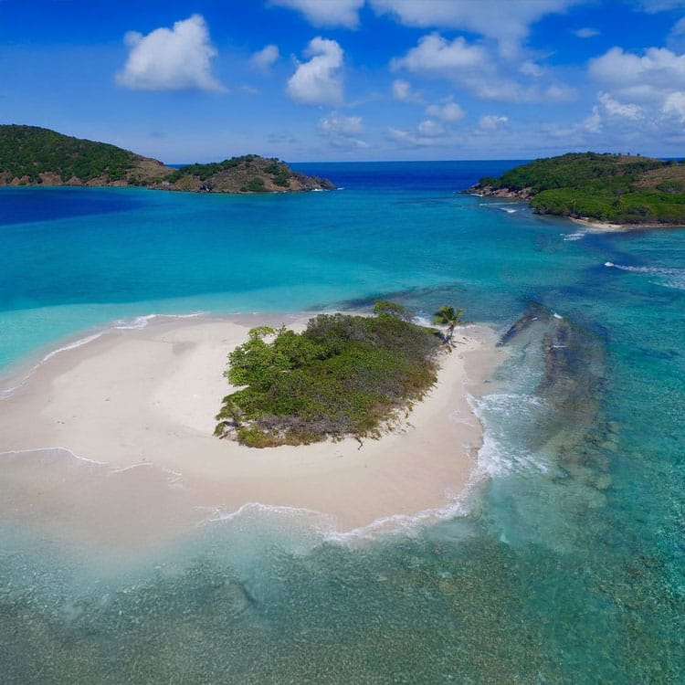 Aerial view visiting sandy cay and surrounding islands in the BVI on a powerboat tour.